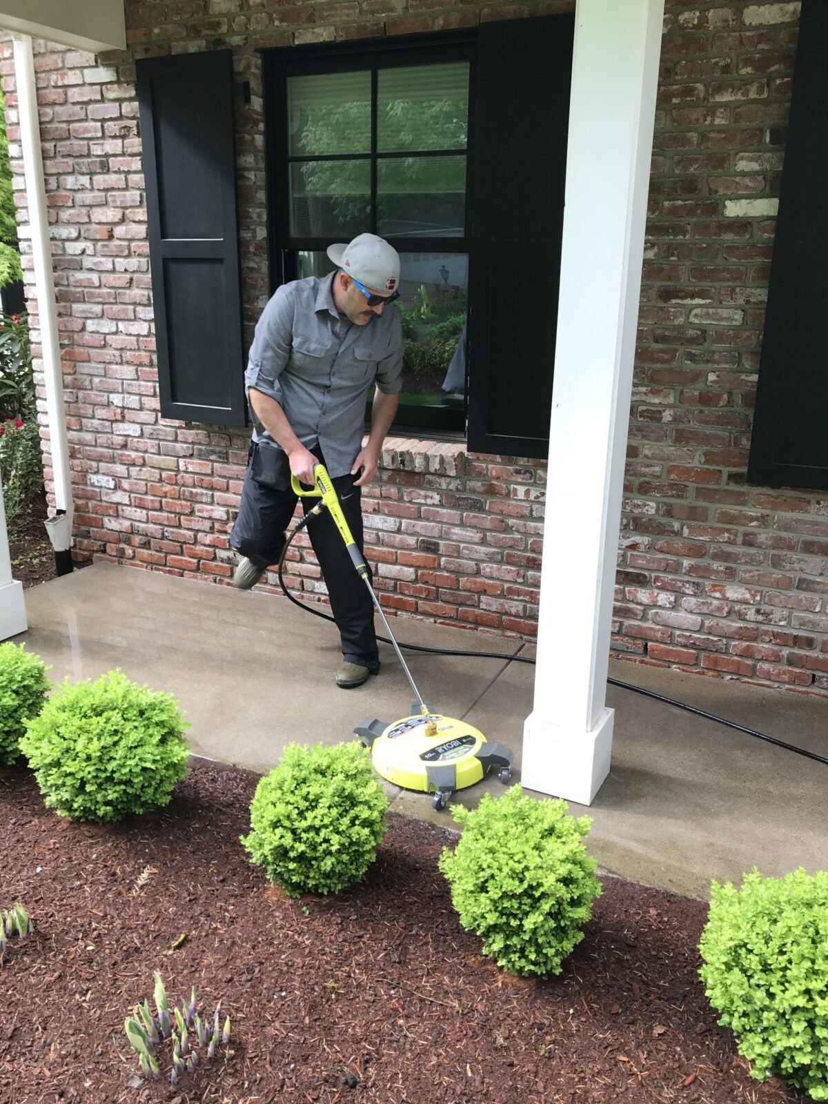 Patrick Griffin pressure washing using professional surface cleaner