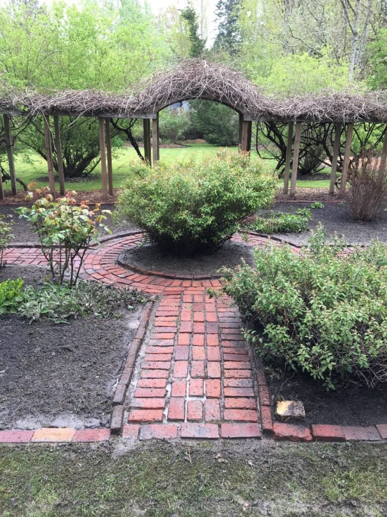 Brick yard garden feature pressure washed by Home Cleaning Pros LLC using our eco-friendly cleaning solutions