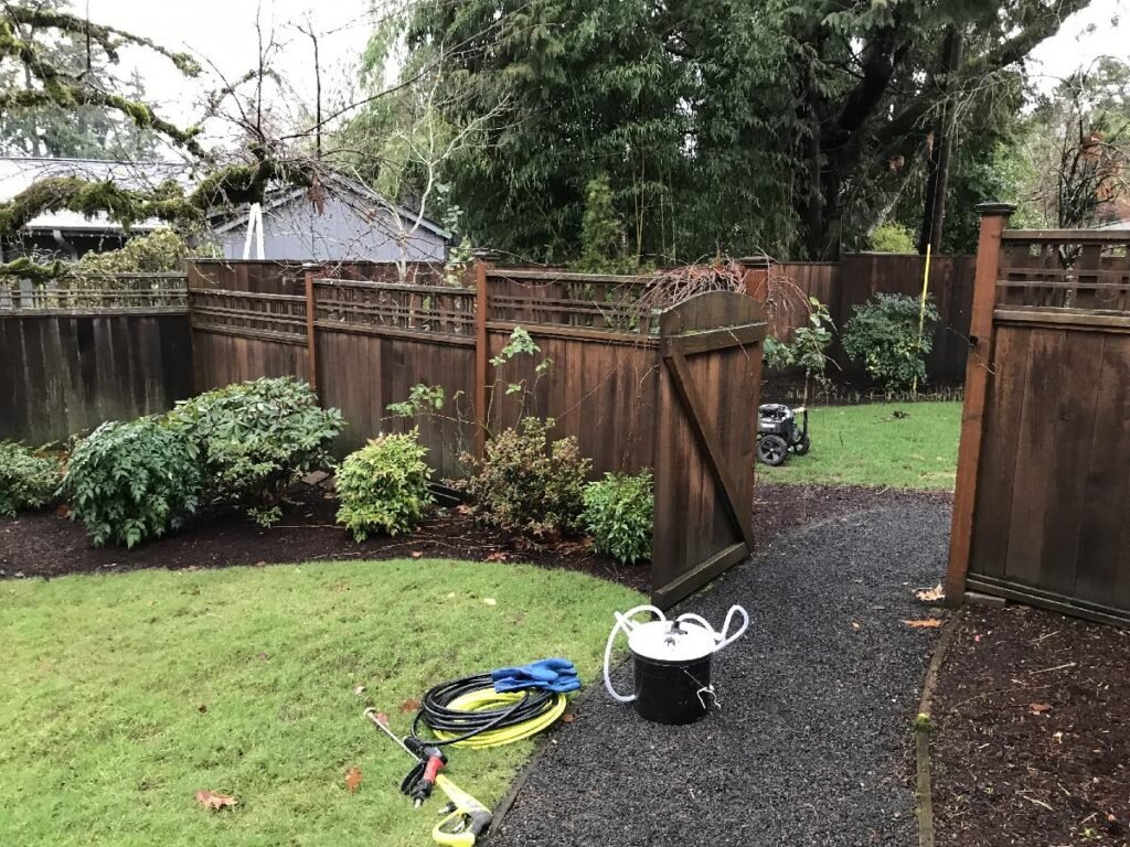 Cedar fence professionally pressure washed by Home Cleaning Pros LLC using our eco-friendly cleaning solutions